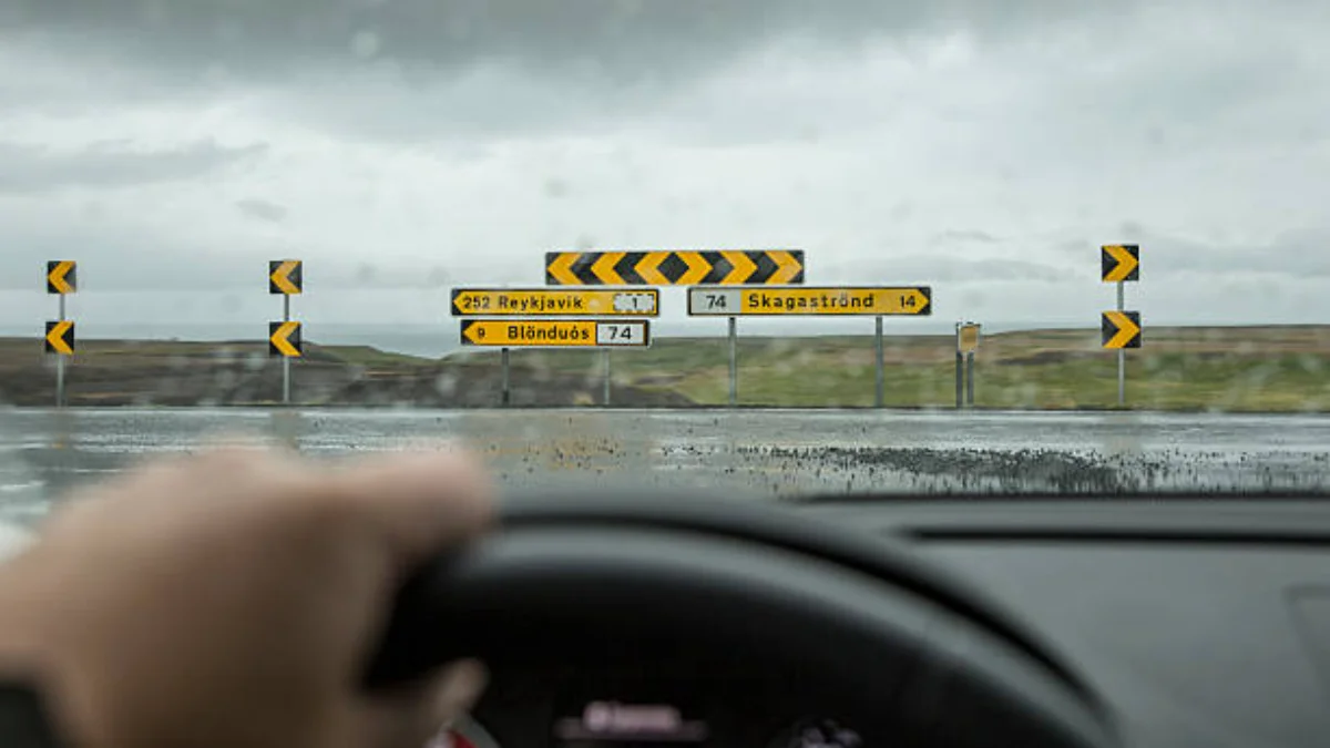 Rain and weather driving test questions guide showing wet road conditions, driver handbook, and safe driving techniques in bad weather